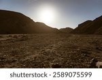 Rocky valley in marsa alam desert, egypt, basking under the bright sun, revealing a stunning landscape of barren beauty and rugged terrain